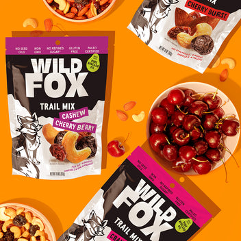 Wild Fox trail mix packages with cherry berries on an orange background