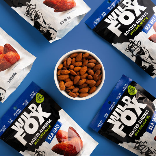 Wild Fox roasted almonds with avocado oil and sea salt on a blue background
